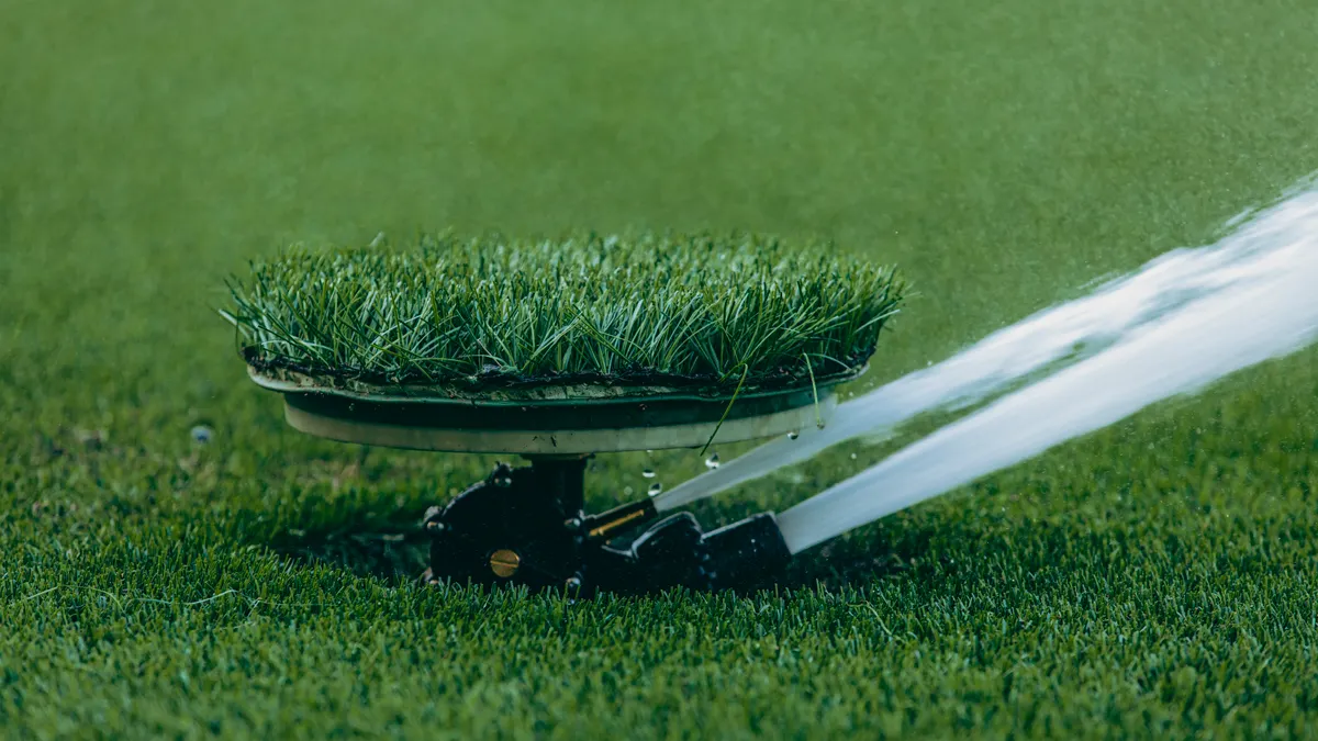How to choose a sprinkler for a backyard lawn Pop-up sprinkler watering turf